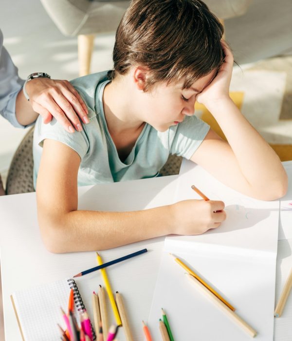 cropped view of child psychologist touching sad kid with dyslexia