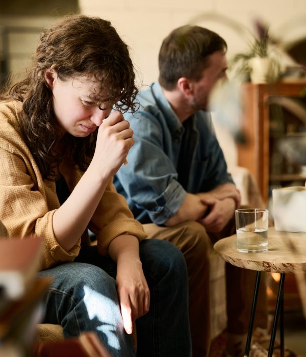 Stressed woman visiting psychologist with husband